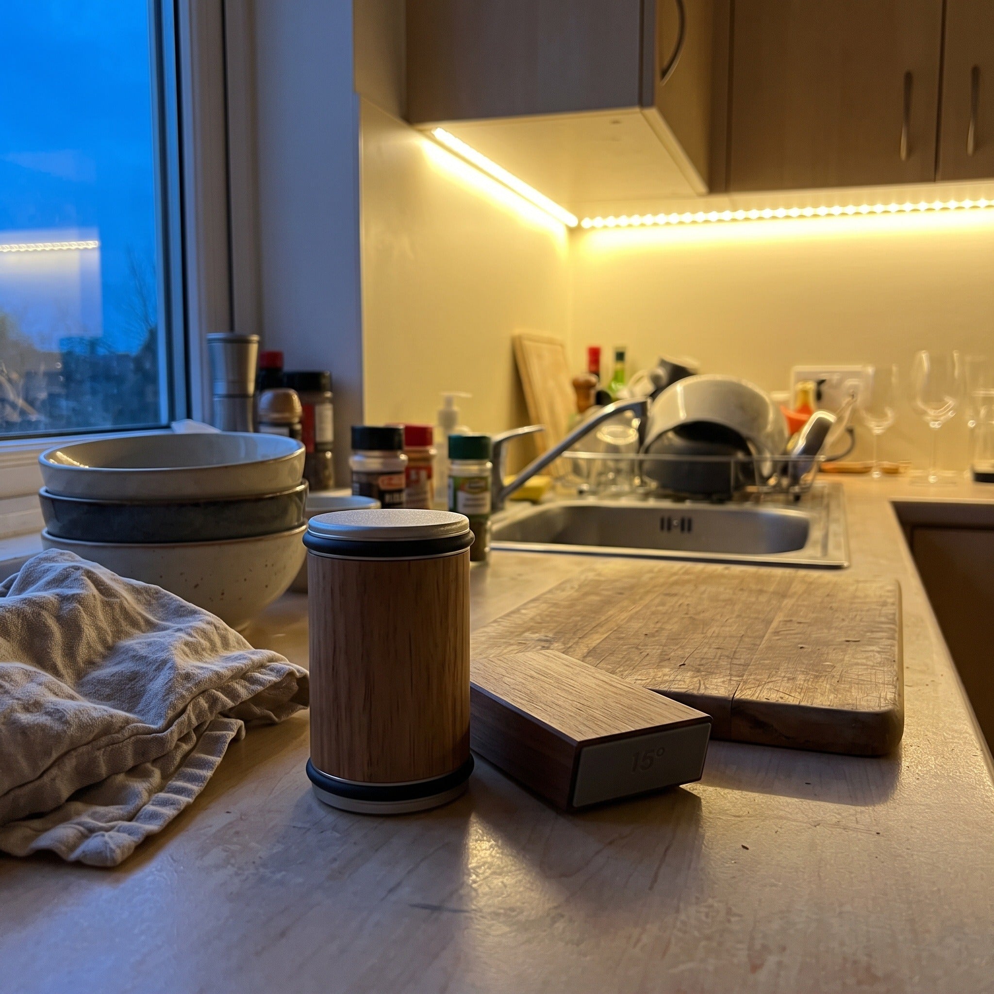 Cutwell resting beside a board and bowls in an evening kitchen